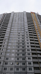 Large construction site on a background of blue sky. Brick, panel apartment building. Industrial theme for design