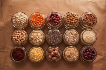 Super food grits in glass jars. Top view. lentils, chickpeas, corn, oats, beans, chia