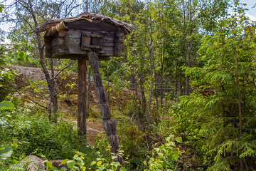 A bear cache, food cache or bear box is a place designed to store food outdoors and prevent bears and other animals from accessing it. Niliaitta. Tree house. Hut.