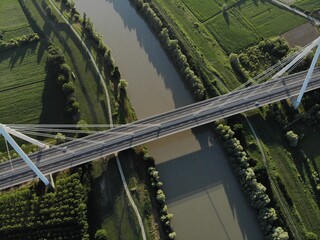 Aerial view of a modern bridge over a river in northern Italy.