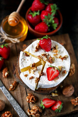 Camembert cheese with strawberries, walnuts and honey. Elegant keto snack. Keto diet.