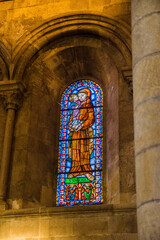 Fototapeta premium stained glass window with the image of a saint in the church