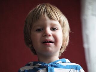 A blond little boy is crying. Crying toddler boy with blue eyes and blond hairs/