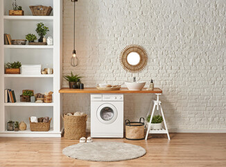 Washing machine in the laundry room, wooden table and shelf style, sink lamp mirror and wicker...