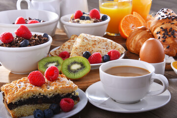 Breakfast served with coffee, juice, croissants and fruits
