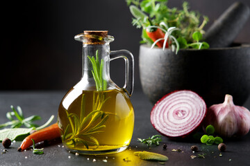 Bottle of Flavored olive oil with rosemary. Traditional Mediterranean Food Ingredients