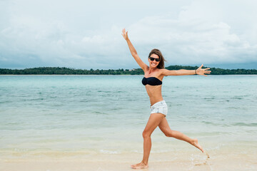 Funny woman playing on the beach