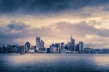Fototapeta premium Retro-style photo of Auckland City downtown skyline at sunset.