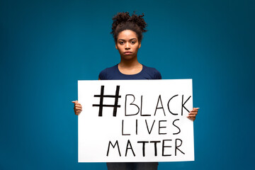 African american woman holding poster Black Lives Matter