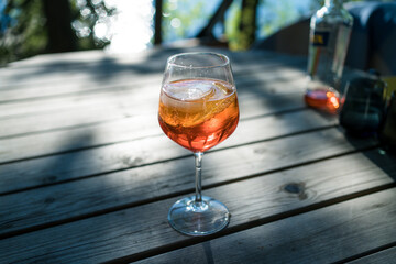 making a summer drink with sparkling wine in sunset outside
