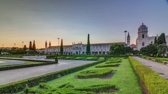 Mosteiro dos Jeronimos at sunset timelapse (Hieronymites Monastery) with green lawn in garden, located in the Belem district of Lisbon, Portugal. Typical example of the Manueline style. UNESCO World