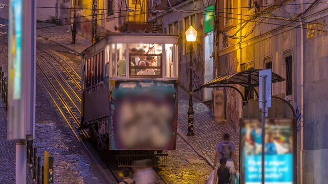 Lisbon's Gloria funicular day to night transition timelapse located on the west side of the Avenida da Liberdade connects downtown with Bairro Alto. It's classified as a national monument opened 1885