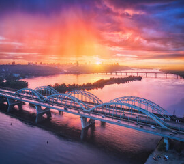Aerial view of beautiful bridge at sunset in Kiev, Ukraine. Landscape with bridge, river, city,...