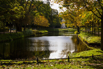 Park in Berlin, water, trees and autumn time, urban recreation.