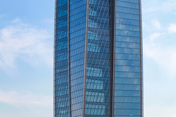 Fragment of the facade of the office building against the blue sky.