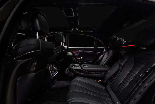 Comfortable interior of prestige modern car. Back leather seats with  ambient light.