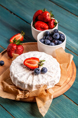 Fresh strawberries and brie cheese wooden board. banner menu recipe place for text