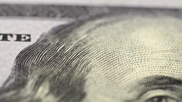 Extremely close-up plan view of a hundred dollar banknote. USA paper currency under the microscope.