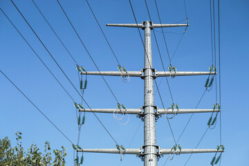 High voltage pole with wires through which electricity flows. Power lines and substations for nuclear power plants. Industrial theme for design