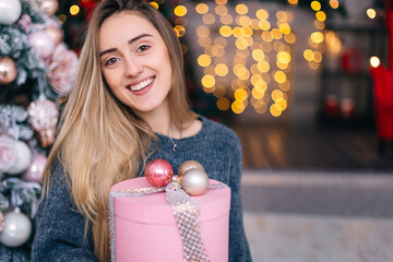 portrait of a girl with gentle makeup and a gift in her hands on