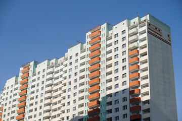 Large construction site on a background of blue sky. Brick, panel apartment building. Industrial theme for design