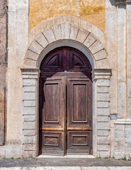 vintage house weathered entrance arched brown door, Rome Italy