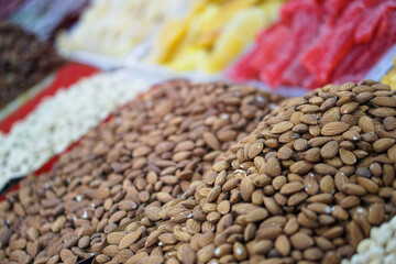 Rack on the market with dried fruits and nuts and Turkish sweets. Vegetarian food mix. Stock photo background for business