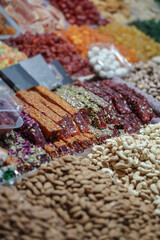 Rack on the market with dried fruits and nuts and Turkish sweets. Vegetarian food mix. Stock photo background for business
