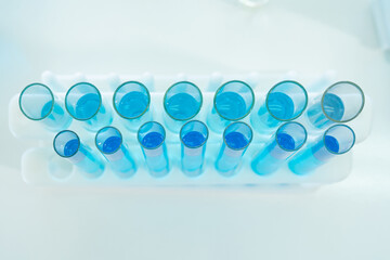 Asian Scientist working on blue test tube to analysis and develop vaccine of covid-19 virus in lab...