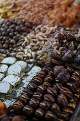 Rack on the market with dried fruits and nuts and Turkish sweets. Vegetarian food mix. Stock photo background for business