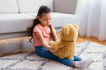 Asian Girl Sitting With Teddy Bear Suffering From Loneliness Indoors