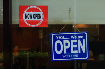 Selective focus on blue and white open sign after lifting lockdown due to coronavirus pandemic