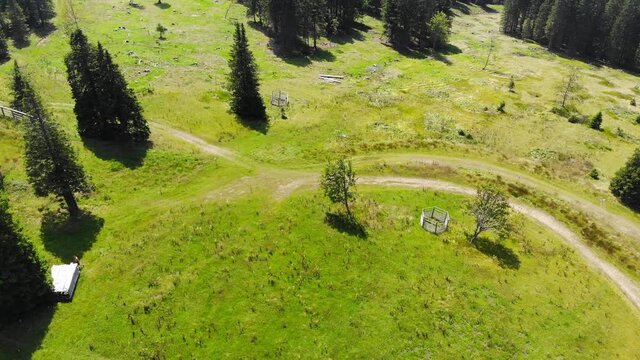 Rogla Slovenia resort grounds with forest hike trails during spring season, Aerial flyover shot