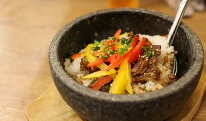 Bulgogi (Korean dish of grilled beef) on rice in a stone bowl in a Japanese restaurant