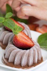 Chocolate fudge garnished with half a strawberry with petals. Garnished with sprigs of mint and...