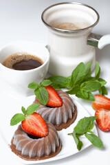 Chocolate fudge garnished with half a strawberry with petals. Garnished with sprigs of mint and...