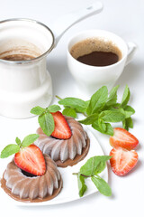 Chocolate fudge garnished with half a strawberry with petals. Garnished with sprigs of mint and...