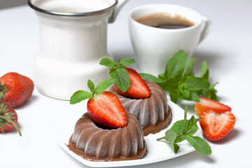 Chocolate fudge garnished with half a strawberry with petals. Garnished with sprigs of mint and...