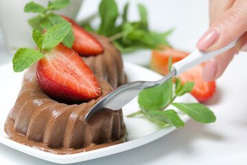 Chocolate fudge garnished with half a strawberry with petals. Garnished with sprigs of mint and...