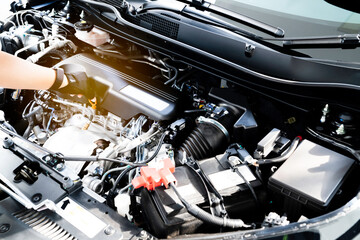 Fototapeta premium Services car engine machine concept, Car mechanic checking a car engine and car service and maintenance.