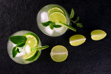Two mojito cocktail on a black background. Flat lay. Top view.