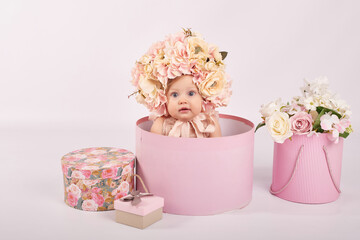 Sweet funny baby in hat with flowers. Easter greeting card, copyspace for your text. Poster for...