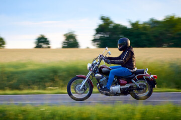Obraz na płótnie Canvas Unidentified man driving a chopper motorcycle