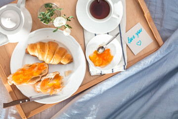 Breakfast in bed. Love note. Honeymoon.  Sunny morning at the hotel. In the process of eating.