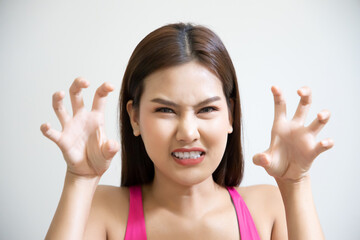 face portrait of sad unhappy girl; portrait of upset angry frustrated southeast asian woman; young adult southeast asian woman model