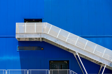 emergency exit from a building against a blue wall
