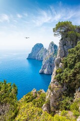 Famous Faraglioni Rocks near Capri Island, Italy. Beautiful paradise image with azure sea in summer sunny day.