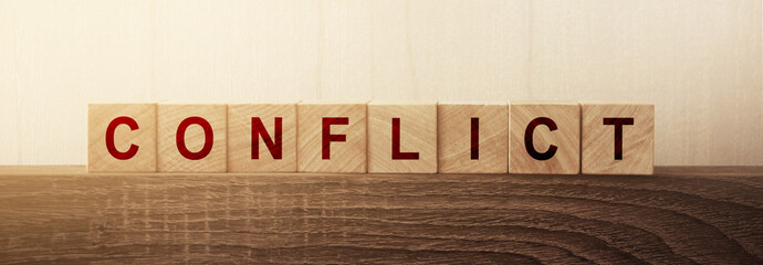 Conflict Word on Wooden Cube. Conflict of interests solution compromise business concept
