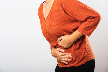 Asian woman she sick have stomach ache holds hands on abdomen, part of body, female having painful stomachache she abdomen bloating or chronic gastritis, studio shot isolated on white background