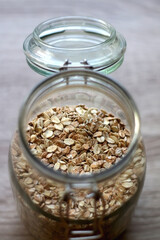 Glass jar with oats in the kitchen. Selective focus.